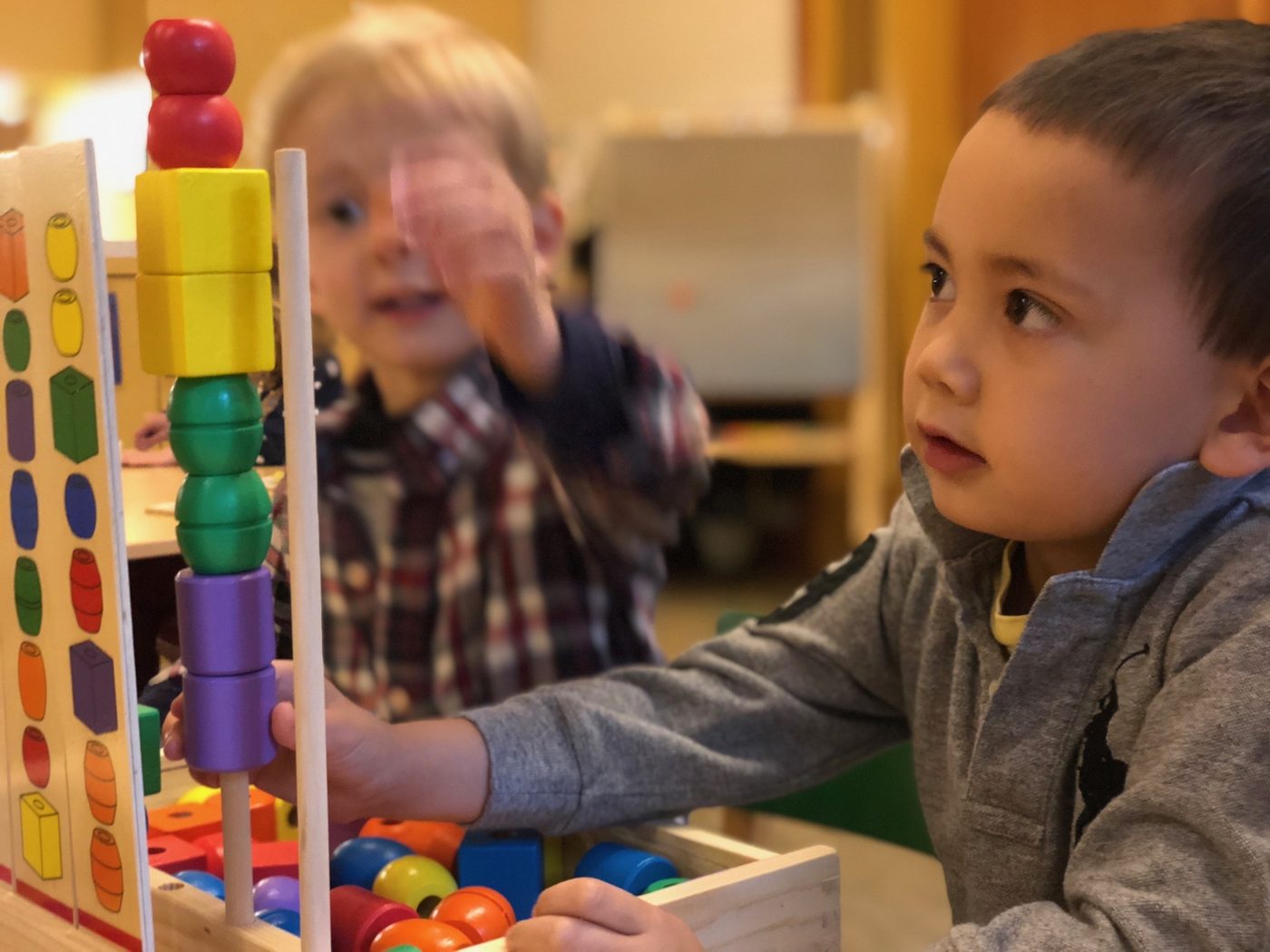 Children playing with colorful toy at The Ross Preschool